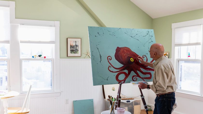Man painting in octopus in his home