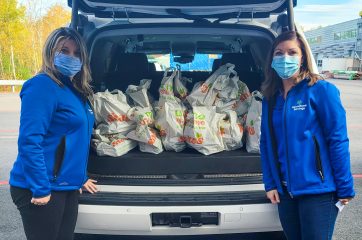 Staff with purchased groceries to donate