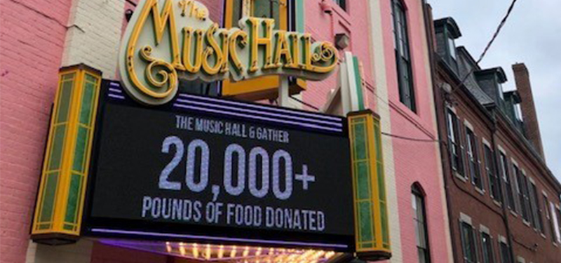 Music hall with sign that reads 20,000+ pounds of food dontated