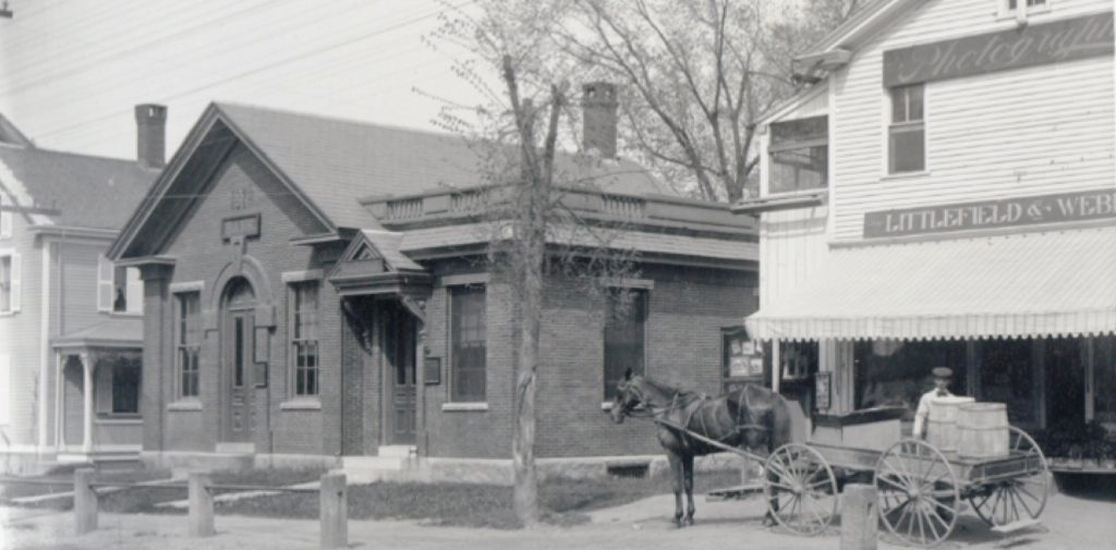 A photo of a horse and buggy outside the bank during its Grand Opening in 1871.