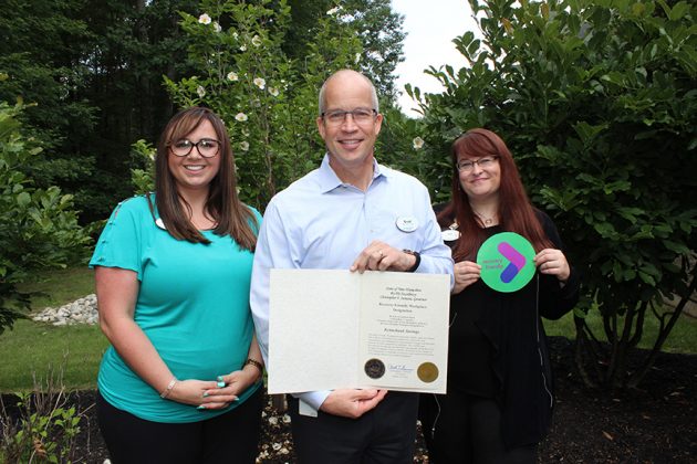 CEO Bradford C.Paige,Community Relations and Social Responsibility Manager Liz Torrance, and Human Resources Manager ShawnaDellamonica pose with the Bank's Recovery Friendly Workplace designation.