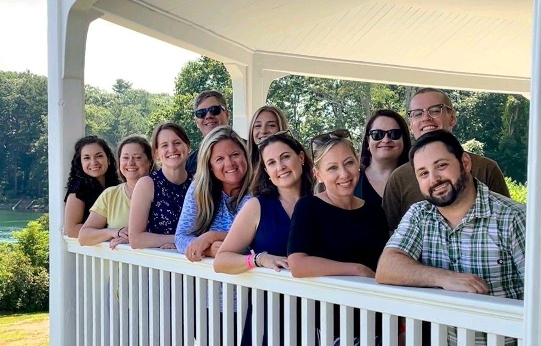 The Kennebunk Savings Marketing team poses for a group photo on the porch at Carey Cottage in Portsmouth.
