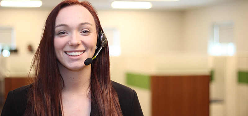 Smiling woman wearing headset.