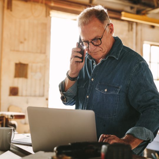 business man on computer in his shop
