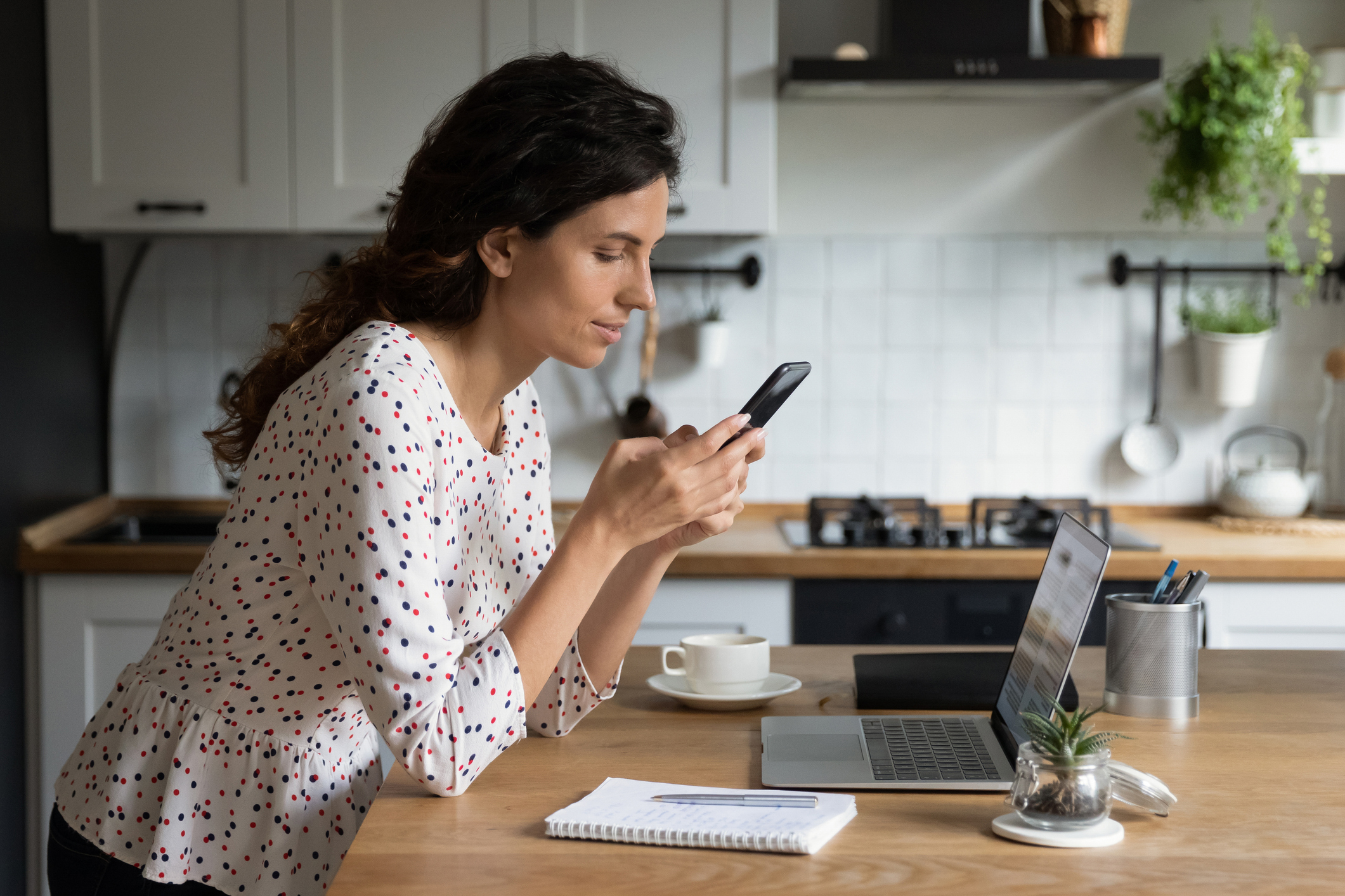 woman on phone and laptop